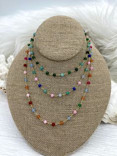 Are you looking for a unique way to add a splash of color to your jewelry designs? Our Colorful Stone Beaded Rosary Chains are the perfect way to do just that! Each chain is made with 4.5mm stone beads on gold wire and comes in 4 different styles. Style #1 features mixed green stone beads, style #2 features green, pink, and blue stone beads, style #3 features pink, red, orange, green, and blue stone beads, and style #4 features light blue stone beads. Each chain is sold by the foot, so you can g Multicolor Beaded Chain Jewelry With Round Beads, Multicolor Round Beaded Chain Jewelry, Multicolor Oval Bead Necklaces 8mm, Multicolor Oval Beads Necklace With 8mm Beads, Multicolor Necklaces With 8mm Oval Beads, Multicolor Crystal Necklaces With Beaded Chain, Multicolor Beaded Chain With Round Beads, Multicolor Round Beaded Chain Beads, Multicolor Crystal Necklaces With 8mm Round Beads