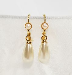 "Bridal Pearl Earrings, Pearl Stud Earrings, Bridal Earrings, Bridal tear drop pearl earrings, Wedding accessories, Gold and pearl jewelry for the bride. The bridal pearl earrings, features Swarovski teardrop pearl with a stud gold coated earring, and tiny Swarovski pearl inlay. The studs can be replaced with a hook hanging earring also with Swarovski pearl inlay. (Appear in the fourth photo). The design is very delicate, made with fine 24K gold plated earrings, NICKEL FREE. You can choose your Formal Teardrop Earrings With Pearl Charm, Classic Teardrop Earrings For Mother Of The Bride, Formal White Teardrop Earrings With Elegant Design, Classic Teardrop Bridal Earrings For Mother Of The Bride, Delicate Pearl Drop Teardrop Earrings For Formal Occasions, Classic Teardrop Pearl Earrings For Wedding, Classic Pearl Drop Earrings For Wedding, Classic Pearl Drop Bridal Earrings, Classic White Teardrop Earrings For Formal Occasions