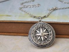 silver compass locket Vintage Round Compass Jewelry, Vintage Round Compass Pendant Jewelry, Vintage Silver Compass Design Jewelry, Vintage Compass Design Round Pendant Jewelry, Vintage Silver Jewelry With Compass Design, Vintage Compass Design Jewelry Gift, Vintage Compass Design Round Necklace, Vintage Engraved Pewter Jewelry, Antique Silver Medallion Locket Necklace With Vintage Charm