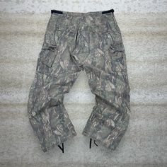 "Vintage Military Hunting Camo Tactical Pants Baggy Fit Double Knees Cargos Crazy Woodland Pattern Large Regular 90s Skate / Streetwear Great Condition: 9/10 Men's Size:  Waist: 36\" Length (inseam): 30\" Leg Opening: 8.5\" Thigh Opening: 14\" Front Rise: 13\"" Combat Parachute Pants With Multiple Pockets, Tactical Camouflage Cargo Pants With Pockets, Baggy Combat Cargo Pants For Outdoor, Casual Camouflage Cargo Pants For Hiking, Urban Camouflage Parachute Pants With Pockets, Tactical Khaki Pants For Streetwear, Baggy Military Cargo Jeans For Outdoor, Tactical Camouflage Bottoms With Pockets, Tactical Camouflage Cargo Pants