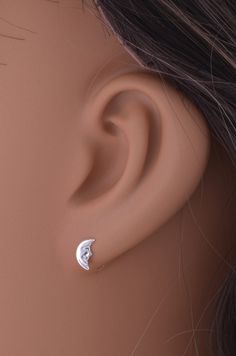 Illuminate your jewelry collection with these Sterling Silver Ladies Dainty Smiling Crescent Moon Stud Earrings. Crafted from high-quality 925 sterling silver, these enchanting earrings feature a delicate half-moon design, complete with a charming smiling crescent moon. Measuring 8mm in length and 4mm in width, these earrings are perfectly sized to add a touch of celestial elegance to any outfit. The whimsical crescent moon design, combined with the brilliance of sterling silver, makes these earrings a versatile accessory suitable for any occasion. The post and friction backings ensure a secure and comfortable fit, ideal for everyday wear. Each pair of Sterling Silver Ladies Dainty Smiling Crescent Moon Stud Earrings comes beautifully packaged in a silver gift box, making them an excellent Moon Earrings Studs Sterling Silver, Crescent Moon Design, Moon Stud Earrings, Silver Gift Box, Moon Studs, Box Making, Moon Design, Half Moon, Crescent Moon