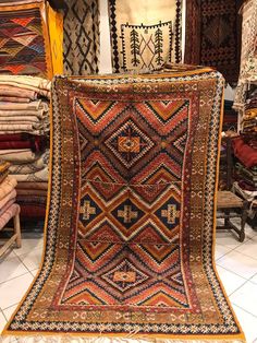 an old rug is on display in a store