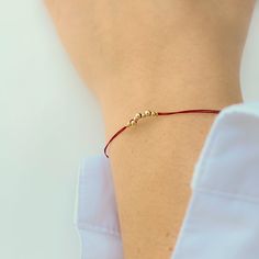 Close-up of hand wearing 2 delicate red thread bracelets, one with gold and one with silver beads detail at center. Threaded Bracelets, Diy Bracelets With String, Good Luck Bracelet, Small Kids, Luck Charm, Luck Charms, Evil Spirits, Diy Bracelet, Diy Bracelets