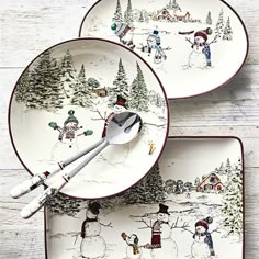 two christmas plates with spoons on them