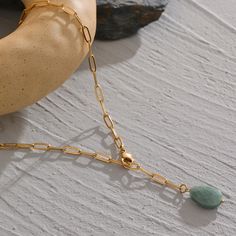 Introducing our newest and most unique accessory, the Green Agate Necklace by ASANA Crystals! This beautiful piece is perfect for those who love minimalism and want to add a touch of nature-inspired elegance to their look. The Green Agate stone is known for its metaphysical properties and is said to promote emotional stability. It's the perfect way to add a bit of zen to your life!

 	Size: 18 inches
 	Free Shipping 2 Days
 	Authentic Green Stone: Green Agate
 	Gold Plated Minimalist Crystal Necklaces With Round Natural Stone Pendant, Minimalist Crystal Necklace With Round Pendant, Minimalist Crystal Necklace With Round Natural Stone Pendant, Minimalist Jade Gemstone Jewelry, Minimalist Jade Round Pendant Necklace, Minimalist Charm Necklace With Natural Stones For Gifts, Elegant Amazonite Necklace For Gift, Modern Necklaces With Natural Stones, Modern Necklaces With Natural Stones For Gifts