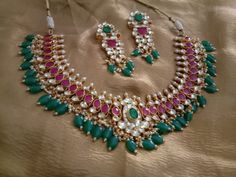 a green and pink necklace with matching earrings