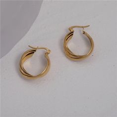 This classically designed hoop is vintage-inspired, but eye-catching. Add a subtle twist to any outfit. Wear this alone or stack with others! These hoops are made of stainless steel, so waterproof! The color remains perfect. Gold: 18k gold platingMaterial: Stainless steelWidth: 21mm Waterproof jewelry Glazd Pouch with every order Free US shipping Easy Exchange & Return policy PRODUCT INFOAll our jewelry are made of stainless steel material. For the gold pieces, we added an 18K PVD gold plating. Classic Stainless Steel Hoop Huggie Earrings, Elegant Stainless Steel Round Hoop Earrings, Gold Plated Hoop Earrings With A Modern Twist, Small Hoop Earrings In Yellow Gold Stainless Steel, Small Yellow Gold Hoop Earrings In Stainless Steel, Yellow Gold Stainless Steel Hoop Earrings, Small Yellow Gold Stainless Steel Hoop Earrings, Twisted Yellow Gold Hoop Earrings, Tarnish Resistant, Elegant Twisted Tarnish-resistant Hoop Earrings