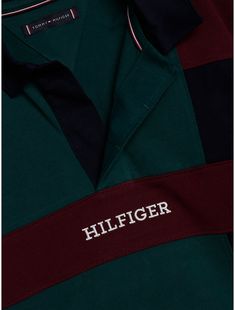 Tommy Hilfiger boys' polo. The varsity-inspired colorblock design adds a sporty touch to this pure cotton polo shirt, finished with a contrast collar and the Hilfiger monotype logo. Part of our Adaptive Collection, designed for ease of dressing in classic Tommy style.  Material: 100% Transitional Cotton ,  In-conversion. Green Cotton Polo Shirt With Ribbed Collar, Sporty Collared Polo Shirt With Logo Print, Green Cotton Sporty Polo Shirt, Green Sporty Cotton Polo Shirt, Sporty Green Cotton Polo Shirt, Sporty Cotton Polo Shirt With Logo Print, Navy Cotton Polo Shirt With Contrast Stripes, Sporty Collared Polo Shirt With Embroidered Logo, Sporty Polo Shirt With Embroidered Logo