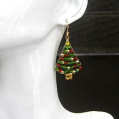 Quality-crafted using: > Bicone Shaped Crystals - Red, Green, Gold - 3mm > Hematite Gold Beads - 3mm > German Style Gold Wire > 14k Gold Plated Solid 925 Sterling Silver (stamped) Ear Wires Lightweight - Hypoallergenic - Nickel Free - Durable    🎄 Christmas Tree Earrings 🎄 Height:      1 1/2 inches  (37.5mm) Width:        1 inch  (25mm) Drop Length:  2 inches  (5cm) ❤️ Earrings are shipped with a pair of very comfortable, easy to use, silicone push backs.  Hypoallergenic - Non-Latex - Great for sensitive skin EAR WIRE INFORMATION: 14k Gold Plated Solid 925 Sterling Silver (Stamped) Ball Dot Fish Earring Hooks.  Sterling Silver and Gold are hypoallergenic and nickel free - a great choice for those who have sensitive skin ✦  All my sterling silver ear wires are coated with a clear protecti Handmade Gold Christmas Earrings, Handmade Gold Earrings For Christmas, Handmade Jewelry For Holiday Celebration, Handmade Holiday Jewelry For Celebration, Gold Earrings With Ear Wire For Holidays, Holiday Gold Earrings With Ear Wire, Gold Drop Earrings For Christmas, Gold Jewelry With Matching Earrings For Holiday, Gold Dangle Earrings For Holiday