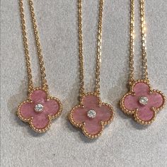 This Clover Rhodonite Necklace features a stunning diamond set in a luxurious pink gold setting. The unique design is both elegant and eye-catching, making it the perfect accessory for any occasion. Crafted with precision and showcasing the healing properties of rhodonite, this necklace adds sophistication and positive energy to any outfit. ADDITIONAL INFORMATION Color: Pink Gold Stone: Cubic Zirconia, Rhodonite Material:925 Sterling Silver - 18k Gold Plated- 18k Real Gold ( contact us via insta Rhodonite Necklace, Thigh Jewelry, Simplistic Jewelry, Pink Gold Necklace, Van Cleef And Arpels Jewelry, Real Gold Jewelry, Trendy Necklace, Detailed Jewelry, Jewelry Accessories Ideas