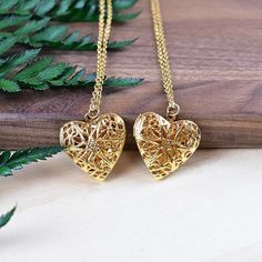 This necklace is made from a gold plated locket charm. The locket is in a shape of a simple heart and opens so you can put something special inside. The front of the locket is an intricate filigree design with cut outs. The locket hangs from a gold stainless steel chain. You can choose the style and length of the chain. Please choose the length you would like the necklace in. Please choose the chain style you would like your pendant on. Please note that all necklaces are handmade and may differ Gold-tone Gold Plated Locket Necklace Gift, Gold Locket Necklace As Gift For Her, Dainty Gold Plated Locket Necklace Gift, Dainty Gold Locket Necklace As Gift For Her, Gold Plated Locket Necklace As A Gift, Gold Heart-shaped Brass Necklace, Dainty Gold Locket Necklace For Gifts, Gold Heart Pendant Locket Necklace In Brass, Gold-plated Medallion Locket Necklace Gift