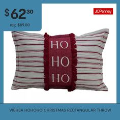 a red and white striped pillow with the words ho ho ho on it's side