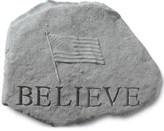 a stone with the words believe and an american flag on it