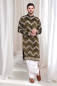 Olive kurta with threadwork chevron patterns, embellished by mirrorwork. Comes with patiala. - Aza Fashions Eid Kurta With Multicolor Embroidery And Mirror Work, Multicolor Embroidered Kurta With Mirror Work For Festive Occasions, Ceremonial Kurta With Mirror Work For Transitional Season, Multicolor Embroidered Kurta With Gota Work For Diwali, Designer Multicolor Embroidered Kurta With Gota Work, Diwali Kurta With Multicolor Embroidery And Gota Work, Transitional Ceremonial Kurta With Mirror Work, Multicolor Embroidered Straight Kurta With Gota Work, Designer Multicolor Embroidery Kurta With Gota Work