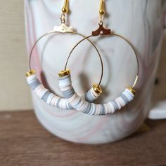 "+ Style name: Pale Pastel with Gold Beaded Hoops + beaded dangle hoop earrings with clay heishi beads and gold bead accent + Hoops are 1 1/2\" diameter + gold hoops with ear wire + All lizcorcreative hoop earrings will come packaged on a hand-stamped kraft earring card in a clear sealed bag Free Domestic Shipping Follow along Instagram https://www.instagram.com/lizcorcreative/ Facebook https://www.facebook.com/profile.php?id=100063235479850 Pinterest https://www.pinterest.com/lizcorrinne/ If th Heishi Earring Ideas, Heishi Beads Jewelry With Dangling Beads As Gift, Bohemian Heishi Beaded Earrings With Dangling Beads, Bohemian Dangle Earrings With Heishi Beads, Handmade Heishi Beads Earrings For Gift, Heishi Beads Dangle Earrings For Gift, Handmade White Heishi Beads Earrings, Colorful Heishi Beads Earrings As Gift, Bohemian Heishi Beads Dangle Earrings