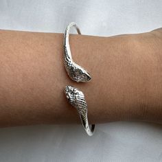 Crafted from solid .925 sterling silver, this Snake Bangle embodies transformation and eternal elegance— honored symbols. A perfect symbol of rebirth and divine authority, it offers a meaningful gift or a special touch to your collection. Ideal for the modern woman who carries the essence of strength and renewal. Material & Features: • Solid .925 Sterling Silver Bangle Bracelets• Bangle thickness: approximately 2.5 mm• Standard size: 8", weight approximately 15 grams for the piece• Available siz Gold Ring Indian, West Indian Bangles, Acorn Jewelry, Bracelet Cuffs, Snake Bangle, Gold Initial Ring, Indian Rings, Bracelets Bangle, African Necklace