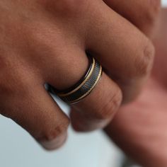 a close up of a person's hand with a ring on it