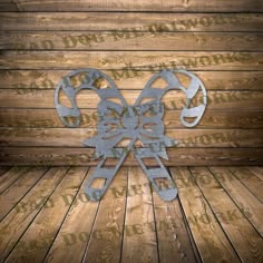 a metal bow on top of a wooden floor next to a wood planked wall