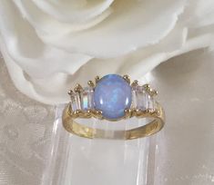 Stunning Vintage Gold Filled Opal Ring Ring size M 1/2 or 6 3/4  - the inside diameter of the ring band is 1.67 cm across (this is a smaller ring size)  the gorgeous Opal is 9 mm long and 6 mm wide  and is securely claw set and the whole setting sits 5.5 mm high the classic Art Deco setting is 1.5 cm long and 6 mm wide and is set with beautiful white accent stones either side   Stamped S925. Total weight is 2.70 grams A stunning Ring, in excellent condition, with minimal wear (Box for display pu Blue Hallmarked Opal Ring For Wedding, Classic Blue Opal Round Ring, Classic Blue Opal Ring For Anniversary, Vintage Blue Opal Ring For Anniversary, Blue Hallmarked Moonstone Ring For Anniversary, Deco Dress, Art Deco Dress, Small Ring, Large Ring