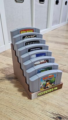 a set of nintendo games sitting on top of a wooden floor next to two doors