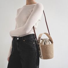 Brown raffia bucket bag with white detailing from Chloé. The Woody tote bag is handwoven from partly upcycled materials by independent craftswomen in Kenya. It features a drawstring fastening and a long leather strap for shoulder and crossbody wear. It is complete with an embroidered Chloé logo for graphic contrast and signature touch.Measurements: L17 x H16 x W16cmMade in Italy Beige Woven Bucket Bag With Round Handle, Beige Handwoven Top Handle Bucket Bag, Chic White Basket Straw Bag, Chic Handwoven Natural Bucket Bag, Chic Natural Handwoven Bucket Bag, Eco-friendly Beige Bucket Bag For Shopping, Chic Handwoven Straw Bucket Bag, Casual Neutral Bucket Bag Tote, Eco-friendly Woven Bucket Bag With Top Handle