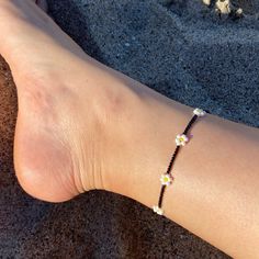 🌊 Handmade in Marina Del Rey, Southern California Daisies at Night Beaded Anklet is perfect for layering with other anklets, on the sandy beach, staycation at home or great to wear with any outfit. Each piece is unique as it is handmade and inspired daily. No two are alike. 🌊 Very Lightweight and comfortable 🌊 Premium quality Glass Seed Beads in size 12/0 (approx. 2mm and 3mm)  🌊 Durable nylon thread or Durable monofilament cord 🌊 Silver plated over alloy lobster clasp  🌊 2" extender chain added upon request Black Beaded Bracelets For The Beach, Black Beaded Bracelets For Beach In Summer, Black Beaded Bracelets For Summer Beach, Bohemian Flower Anklets For Summer, Flower Shaped Summer Beach Anklets, Summer Beach Flower Anklets, Flower-shaped Summer Beach Anklets, Beaded Ankle Wrap Anklets For Beach, Beaded Ankle Wrap Anklets For Beach Season