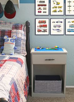 a child's bedroom with blue walls and pictures on the wall above the bed