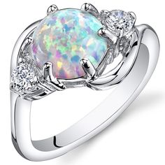 Moonlit magic It's the simple things in life. These whimsical and playful Opal colors will dance with you all day (and night). This graceful ring features a round shape Peora created Opal gemstone in .925 sterling silver. Responsibly sourced in every sense, our created Opal gemstones are physically, chemically, and optically identical to their natural counterparts. We're big fans of eco-luxury. Handcrafted in pure .925 sterling silver goodness, this ring has been carefully coated in an elegant rhodium finish. Our artisans are expertly trained in this process which fortifies the ring's strength, shine and brilliance. Main Stone Lab Created Opal 1.75 Carats, round shape, 8 x 8 mm White color with a SI1-SI2 clarity Accent Stone Cubic Zirconia Round shape, 1 x 1 mm White color with a VS1-VS2 c White Opal Ring, Ring Opal, Fire Opal Ring, Opal Stone, Opal Ring, Sea Glass Jewelry, White Opal, Vintage Bracelets, Ring Sterling Silver