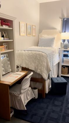 a bedroom with a bed, desk and chair next to a bookcase filled with books