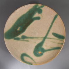 a green and white plate with an animal on it