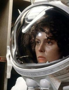 a close up of a person wearing a space suit and looking into the distance with an astronaut's helmet on