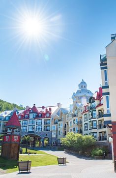 the sun shines brightly over a row of multi - story buildings on a sunny day