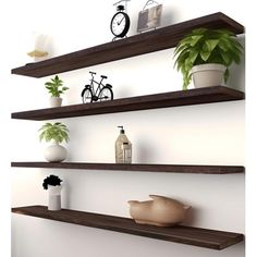 three wooden shelves with plants and vases on them