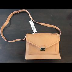 Loeffler Randall Rider Shoulder Bag In New Condition. Color Is Natural/Camel. The Bag Has The Tags, Duster Bag, And Has Never Been Worn. It Includes Tonal Hardware, Push-Lock Front Closure, And Multiple Pockets. Can Be More Over The Shoulder, Crossbody, Or By The Top Handle. Beige Flap Bag With Magnetic Closure For Everyday, Chic Cognac Flap Bag For Everyday Use, Caramel Crossbody Shoulder Bag With Detachable Strap, Chic Cognac Shoulder Bag Satchel, Beige Leather Satchel With Magnetic Closure, Chic Cognac Crossbody Satchel, Beige Satchel With Magnetic Closure For Office, Chic Rectangular Saddle Bag For Shopping, Beige Office Satchel With Magnetic Closure