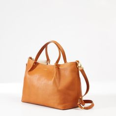 From a busy work life to a leisure time getaway, this luxe tote will quickly become your go-to bag. Beautiful and durable, made from high-quality Italian leather, it includes magnetic closure, a flat bottom that allows it to sit up, both handles and a detachable crossbody strap and three interior pockets. A foil debossed monogram finishes this go-to bag for special holidays or every day.  13.5" w x 6" d x 10" h  Handle drop: 5"; Detachable strap: 36" - 40"  Two interior open pockets. Open: 5.25" Mark And Graham, Leisure Time, Sit Up, Work Life, 6 D, Holiday Specials, Crossbody Strap, Magnetic Closure, Italian Leather