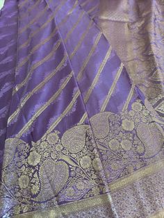 Indian Traditional Light Purple Premium Look Banarasi Satin Silk Saree With Softness and shiny | Party Wear Saree | Light Purple Saree About the Saree - Handloom technique involves the hand -weaving process for each motifs separately. It takes longer on the handloom  as it has a human involvement to have a fine designs ,which make fabric rich and luxurious. Specialty - A full woven With Self Silk Valley Pattern with Attractive Border.  Fabric - Pure Satin Silk Color - Light Purple Length - 5.6Metres Width - 45 inches. Blouse - Saree comes with its own blouse piece. Clean - Only Dry Clean Promise - Silk Banarasi saree. Fall & Pico - Saree comes with Fall and Pico and all finishing. Disclaimer Drawing inspiration from the Great Indian Culture, this Silk Saree is no less than a Fairytale in i Purple Pre-draped Saree With Zari Work For Celebration, Purple Pre-draped Saree For Festivals, Traditional Katan Silk Pre-draped Saree For Party, Gold Lehenga With Zari Weaving For Party, Katan Silk Traditional Wear For Eid Party, Traditional Purple Pre-draped Saree For Party, Diwali Party Sets With Zari Weaving, Party Blouse Piece In Katan Silk With Zari Weaving, Festival Party Blouse Piece With Zari Weaving