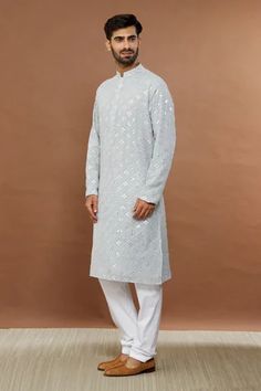 Light grey kurta with mirror embroidery and mandarin collar. Paired with white churidar.
Component: 2
Pattern: Embroidered
Type Of Work: Mirror
Neckline: Mandarin
Sleeve Type: Full
Fabric: Cotton Blend
Color: Grey
Other Details: 
Mirror work
Occasion: Mehendi and Puja - Aza Fashions Ceremonial Kurta With Mirror Work For Transitional Season, Transitional Ceremonial Kurta With Mirror Work, Ceremonial Straight Kurta With Mirror Work, Ceremonial Kurta With Mirror Work For Diwali, Ceremonial Unstitched Kurta With Mirror Work, Unstitched Ceremonial Kurta With Mirror Work, Festive Kurta With Mirror Work For Traditional Ceremonies, Festive Kurta With Chikankari Embroidery Traditional Fit, Festive Chikankari Embroidered Kurta In Traditional Fit