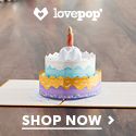 a birthday cake sitting on top of a table with the words lovepop above it