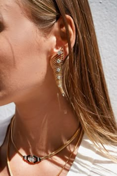 A daring silhouette from the Together Collection, these drop earrings are the epitome of timeless beauty. The complex construction of each piece in this collection is hidden for the fit to be adjustable and flexible for each wearer. An exemplary tribute of Nikos Koulis' intricate techniques and master craftsmanship: these earrings feature a delicate chain crafted as embroidery effortlessly paired with surprising layers of stones. Sophisticated drama meets exceptional elegance in this modern show Elegant Metal Single Ear Cuff, Elegant Metal Ear Cuff For Formal Occasions, Elegant Metal Ear Cuff For Formal Events, Elegant Metal Ear Cuff With Matching Earrings, Elegant Metal Ear Cuff For Evening, Elegant Metal Ear Cuff, Luxury Linear Pierced Earrings For Evening, Elegant Plated Drop Plug Earrings, Elegant Pierced Ear Cuff For Evening