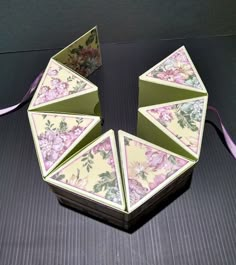 an origami box with pink flowers on it