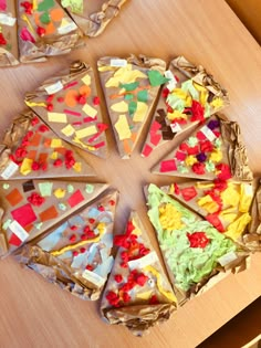 several slices of pizza sitting on top of a wooden table covered in confetti