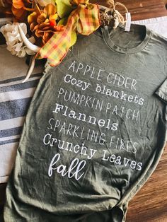 Share what you love about fall with this fall favorites shirt! Autumn Tshirt Designs, Fall Coffee Shirts, Fall T-shirt, Cozy Letter Print Tops For Fall, Diy Fall Shirts Vinyl, Everyday Fall T-shirt With Letter Print, Cozy Graphic Print Tops For Fall, Trendy Green T-shirt For Fall, Everyday Cotton T-shirt For Fall