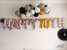 the balloon letters that say happy 30th are in front of a white wall with balloons