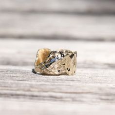 a gold ring sitting on top of a wooden table