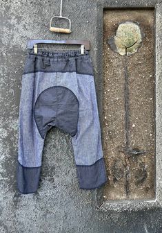 Baggy Cotton Patchwork Jeans, Baggy Patchwork Cotton Jeans, Bohemian Style Denim Blue Cotton Pants, Relaxed Fit Denim Blue Patchwork Pants, Bohemian Denim Blue Cotton Pants, Relaxed Fit Denim Blue Patchwork Bottoms, Blue Recycled Denim Bottoms With Patchwork, Blue Deconstructed Cotton Jeans, Baggy Patchwork Tapered Leg Pants