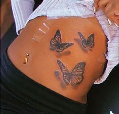 a woman's stomach with butterflies on it and the bottom part of her belly