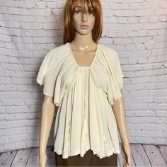 Flatter Sleeve Open Back With Ties Beige Color Crinkled Fabric 100% Viscose Size M Length: 25'' New Without Price Tag, Tag String Still Attached B-19(10) - 2 Flowy Peasant Top With Ruffles, Chic Crinkle Texture Blouse For Day Out, Spring Chic Blouse With Crinkle Texture, Chic Spring Blouse With Crinkle Texture, Casual Ruffled Viscose Blouse, Chic Rayon Blouse With Flutter Sleeves, Cream Peasant Top With Ruffles For Summer, Feminine Beige Blouse With Flutter Sleeves, Feminine Beige Flutter Sleeve Blouse