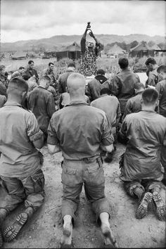 a group of men sitting on the ground