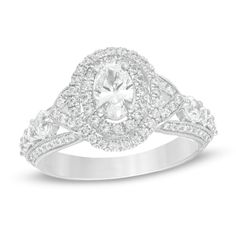 A sublime expression of love, this vintage-inspired diamond engagement ring is anything but ordinary. Crafted in 14K white gold, this luxurious choice showcases a 1/2 ct. oval-shaped diamond wrapped in a double diamond-adorned frame - all atop a gallery shimmering with diamonds. Along the shank, sculpted borders lined with diamonds and intricate milgrain detailing highlight a ribbon of graduated-sized diamonds and create "V"-shaped collars that flank centerpiece. Captivating with 1-5/8 cts. t.w. Oval Diamond Ring For Wedding And Anniversary, Oval Diamond Ring With Brilliant Cut For Anniversary, Oval Brilliant Cut Diamond Ring For Anniversary, Oval Brilliant Cut Diamond Anniversary Ring, Oval Diamond Halo Ring For Anniversary, Oval Diamond White Diamond Ring For Anniversary, Oval Diamond Ring With Center Stone For Anniversary, Oval Diamond Cut Ring For Anniversary, Oval Diamond Cut Anniversary Ring