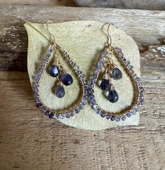 Gold filled hoop earrings with faceted iolite gemstones Teardrop Gemstone Hoop Earrings In Fine Jewelry Style, Fine Jewelry Teardrop Gemstone Hoop Earrings, Teardrop Tanzanite Jewelry For Anniversary, Sapphire Hoop Earrings For Gift, Faceted Tanzanite Jewelry For Anniversary, Faceted Teardrop Sapphire Jewelry, Tanzanite Teardrop Jewelry With Matching Earrings, Gold Tanzanite Teardrop Jewelry, Teardrop Sapphire Faceted Jewelry